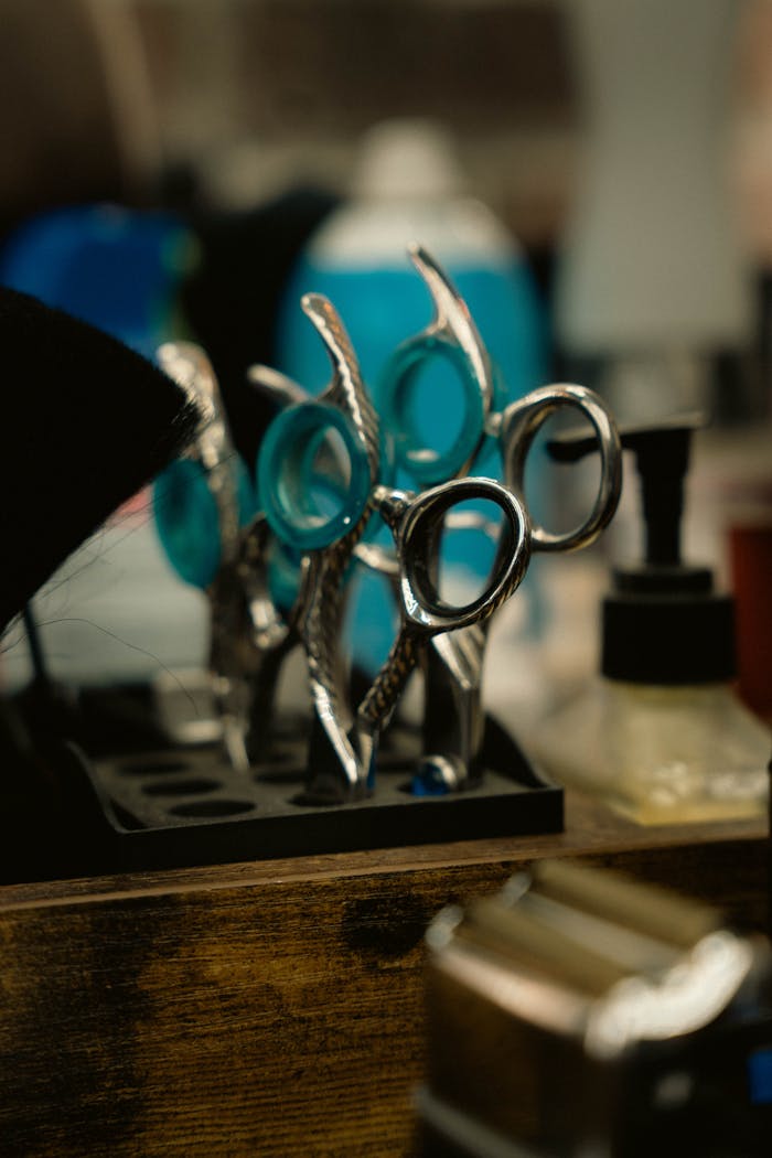 Close-up of professional hairdressing scissors in a salon environment, offering a glimpse into hairstyling tools.